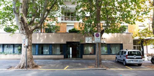 a white van parked in front of a building at Hotel Lis in Asti
