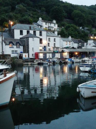 a group of boats docked in a marina at night at The House on the Props in Polperro