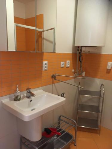 a bathroom with a sink and a mirror at Apartmán 6 Triangel in Donovaly