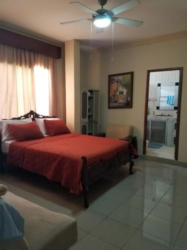 a bedroom with a bed and a ceiling fan at Casa Serena in Guayaquil