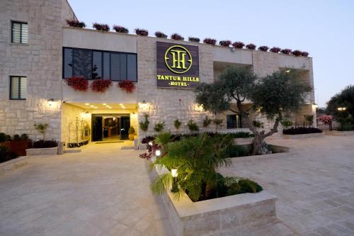 a building with a sign on the front of it at Tantur Hills Hotel - Jerusalem in Jerusalem