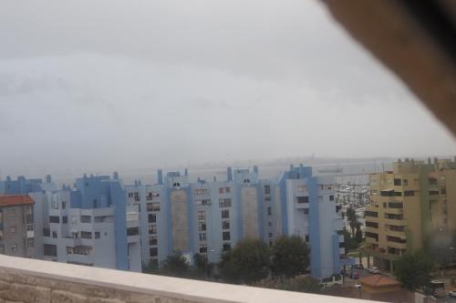 a view of a city with blue buildings at Tiny apartment on the roof touching Gibraltar in La Línea de la Concepción