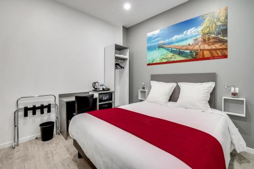 a bedroom with a large bed and a desk at Paris Hotel in Clichy