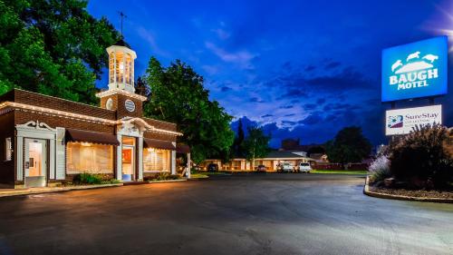 a building with a clock tower on a street at Baugh Motel, SureStay Collection by Best Western in Logan