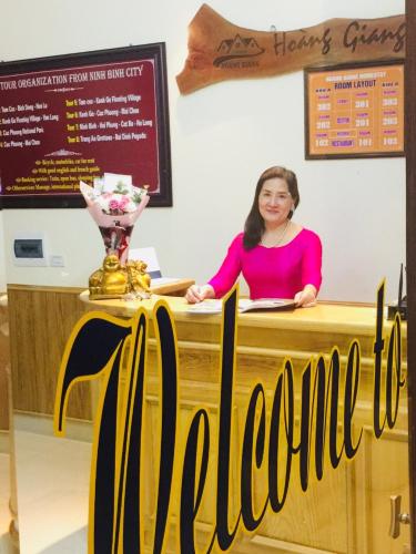 a woman sitting at a counter with a trophy at Hoang Giang Homestay in Ninh Binh
