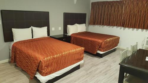a hotel room with two beds in a room at Guest Harbor Inn- Port Of Los Angeles San Pedro in San Pedro