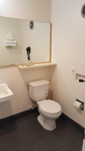a bathroom with a white toilet and a sink at Guest Harbor Inn- Port Of Los Angeles San Pedro in San Pedro