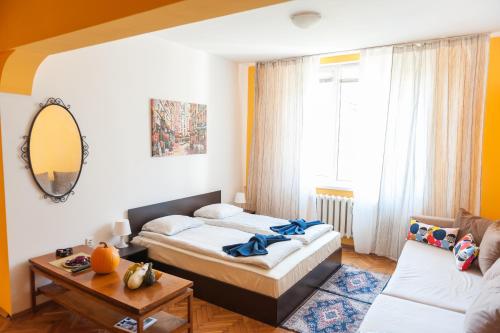 a bedroom with two beds and a table at Vitosha Blvd - Family and Friends Apart in Sofia