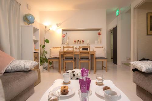 a living room with a table and a dining room at COCO Shinjuku HOTEL in Tokyo