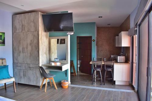 a kitchen with a table and chairs in a room at Hotel Corazón Mexicano in Guanajuato