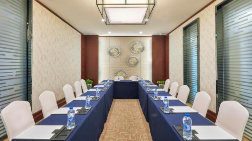 a long table in a room with chairs and water bottles at SSAW Boutique Hotel Ningbo CBD - Family Friendly & Business Travel in Ningbo