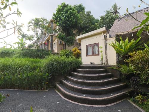 a set of stairs leading to a house at Biyukukung Suite & Spa in Ubud