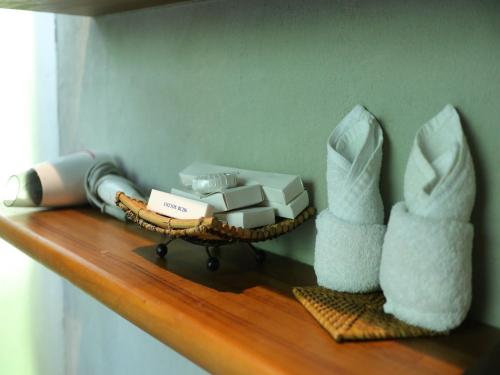 a shelf with a basket of tissues and towels at Biyukukung Suite & Spa in Ubud