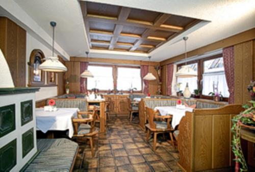 a dining room with tables and chairs in a restaurant at Alpenheim Mathias in Sölden