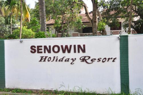 a sign for newcomin holiday resort on a fence at Villa Senowin in Anuradhapura