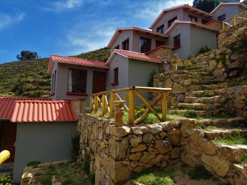 a house on the side of a rocky hill at Utasawa in Comunidad Yumani