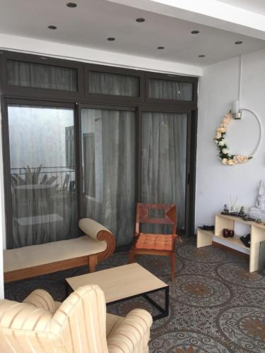 a living room with a couch and a table at Villa Alizee in Port Louis