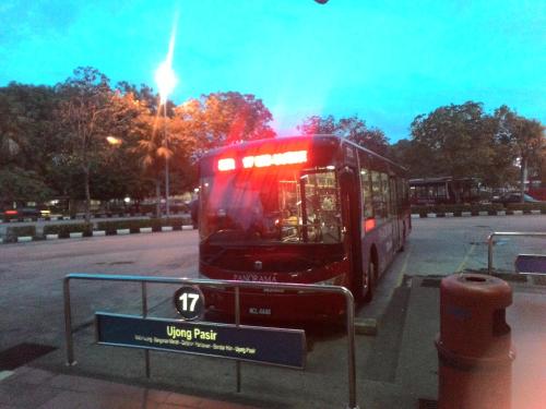 a red bus parked on the side of a street at Costa Mahkota (Family Homestay) @ Mahkota Melaka in Melaka