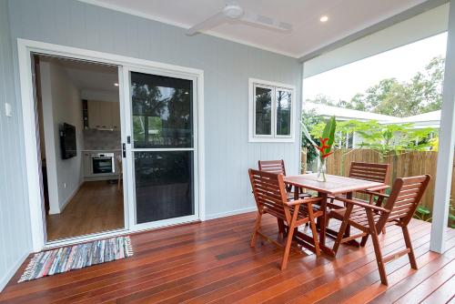 a dining room with a table and chairs at Island Cottages in Nelly Bay