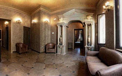 a living room with a couch and chairs in it at Antica Dimora Delle Cinque Lune in Rome