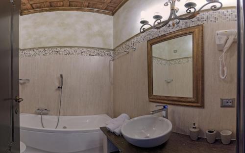 a bathroom with a tub and a sink and a bath tub at Antica Dimora Delle Cinque Lune in Rome