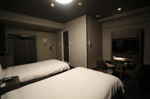 Letto o letti in una camera di Hotel Route-Inn Grand Tokyo Toyocho