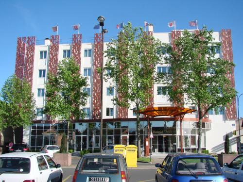 a large white building with cars parked in front of it at Logis Hotels Grand Hotel d'Orléans in Albi