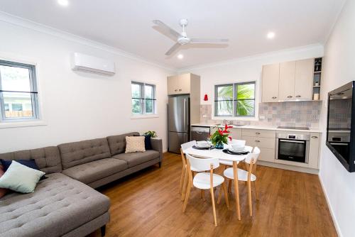 a living room with a couch and a table at Island Cottages in Nelly Bay