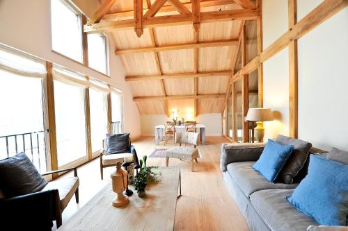 a living room with a couch and chairs and windows at Manoir de Malagorse in Cuzance