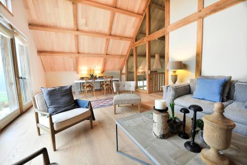 a living room with a couch and chairs and a table at Manoir de Malagorse in Cuzance