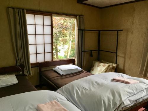 Voodi või voodid majutusasutuse Guest House YAMASHITA-YA toas