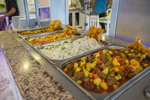 a buffet line with trays of different types of food at Halıcı Hotel Marmaris in Marmaris