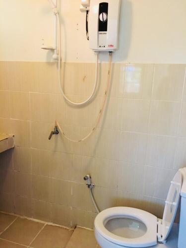 a bathroom with a toilet with a shower in it at JJ&J Garden in Pai