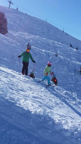 a couple of people skiing down a snow covered slope at Gästehaus Schwoagerhof in Fügen