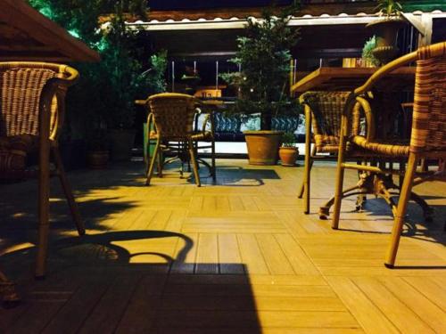 a group of chairs and tables on a wooden deck at Araz Apart in Bursa