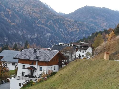 a house on a hill with mountains in the background at Telfeshof in Fiss