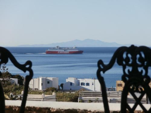 a cruise ship in the water with buildings at Galini Bungalows in Kionia