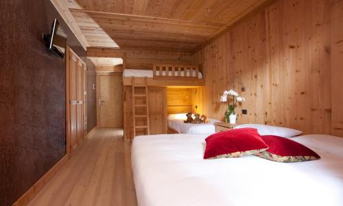 
a bedroom with a bed and a dresser at Hotel Funivia in Bormio
