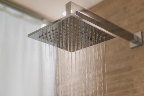 a shower head with water pouring out of it at Hotel Polo in Rimini