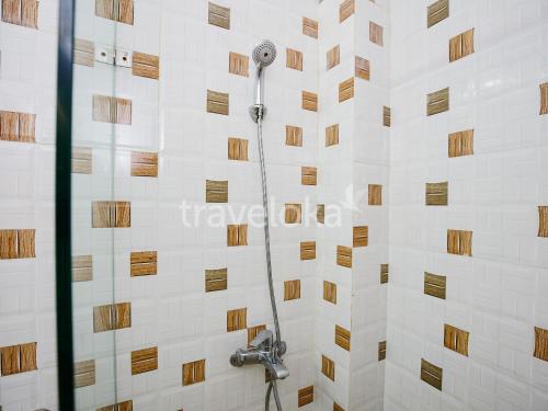 大叻的住宿－吉亞罕酒店，带淋浴的浴室(带瓷砖墙)