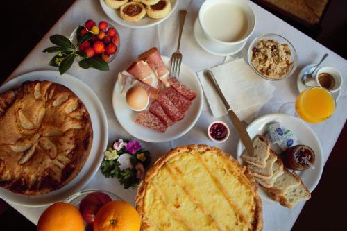 a table full of breakfast food with eggs and fruit at Agriturismo La Ripa in Montorio Romano
