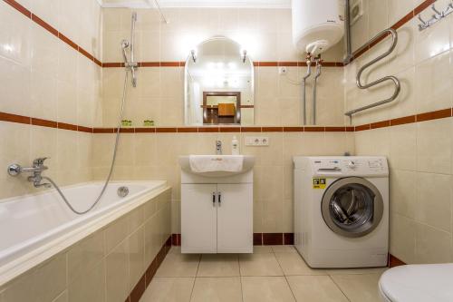 a bathroom with a washing machine and a sink at Cheap Apartments in Kyiv