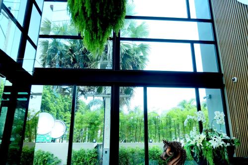 a large window in a building with plants at Montana Hotel Songkhla in Songkhla