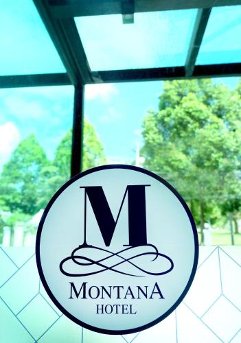 a sign for a montmartre hotel with a hat at Montana Hotel Songkhla in Songkhla