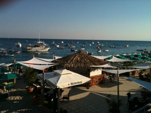 a group of umbrellas and boats in the water at Hotel Mediterraneo in Roccella Ionica