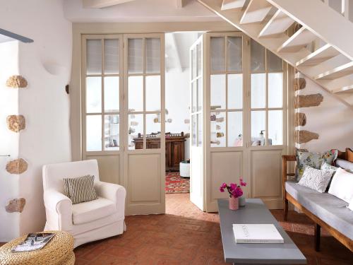 a living room with a couch and a table at Patmos Eye Boutique Hotel & Villas in Skala