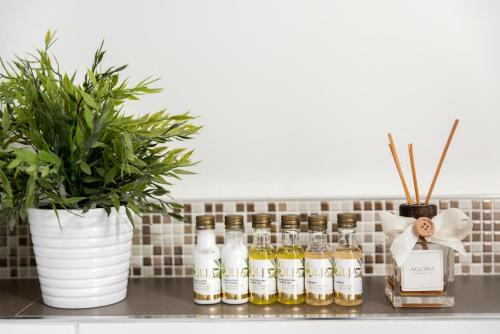 a row of bottles of essential oils on a counter at Agora Apartments in Sorrento