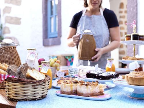 a woman standing in front of a table of food at Patmos Eye Boutique Hotel & Villas in Skala