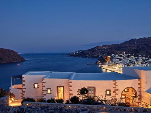 a building with a view of the ocean at night at Patmos Eye Boutique Hotel & Villas in Skala