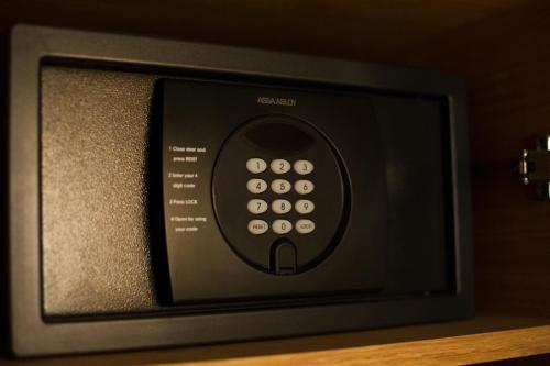 a television with a remote control sitting on a shelf at ONOMO Hotel Casablanca City Center in Casablanca